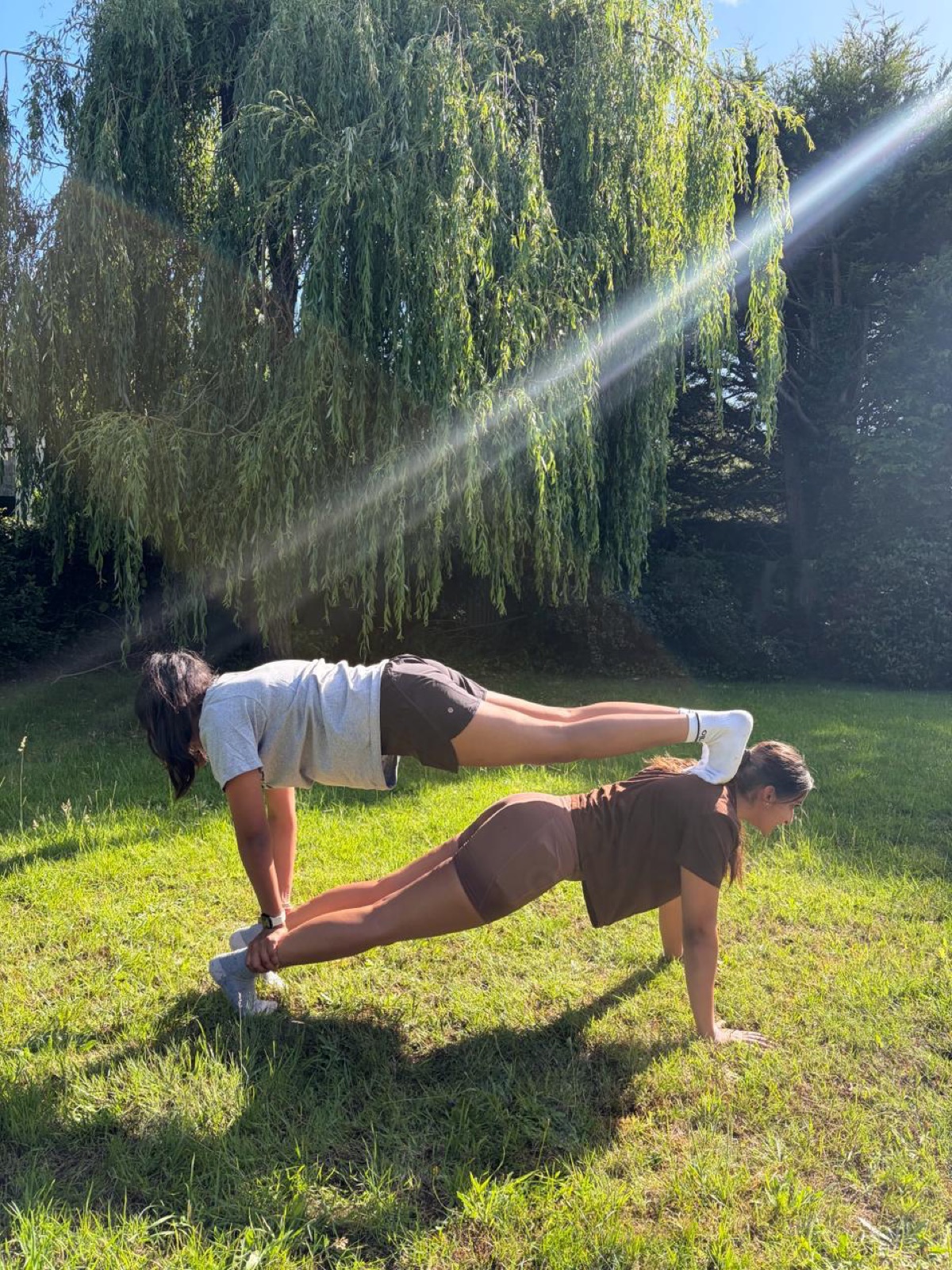 Partner plank practice in the garden