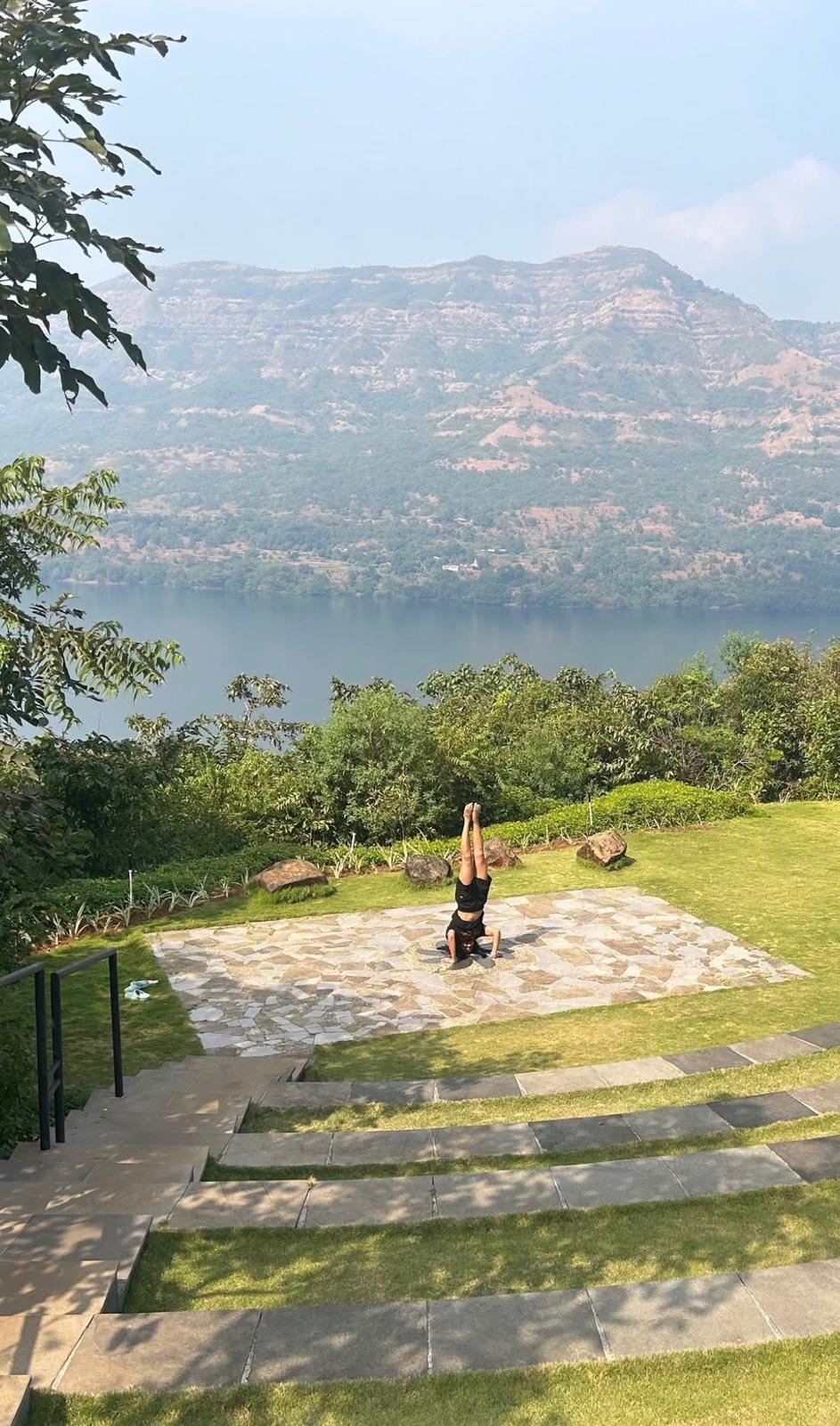 Seated meditation on a stone terrace above a lake