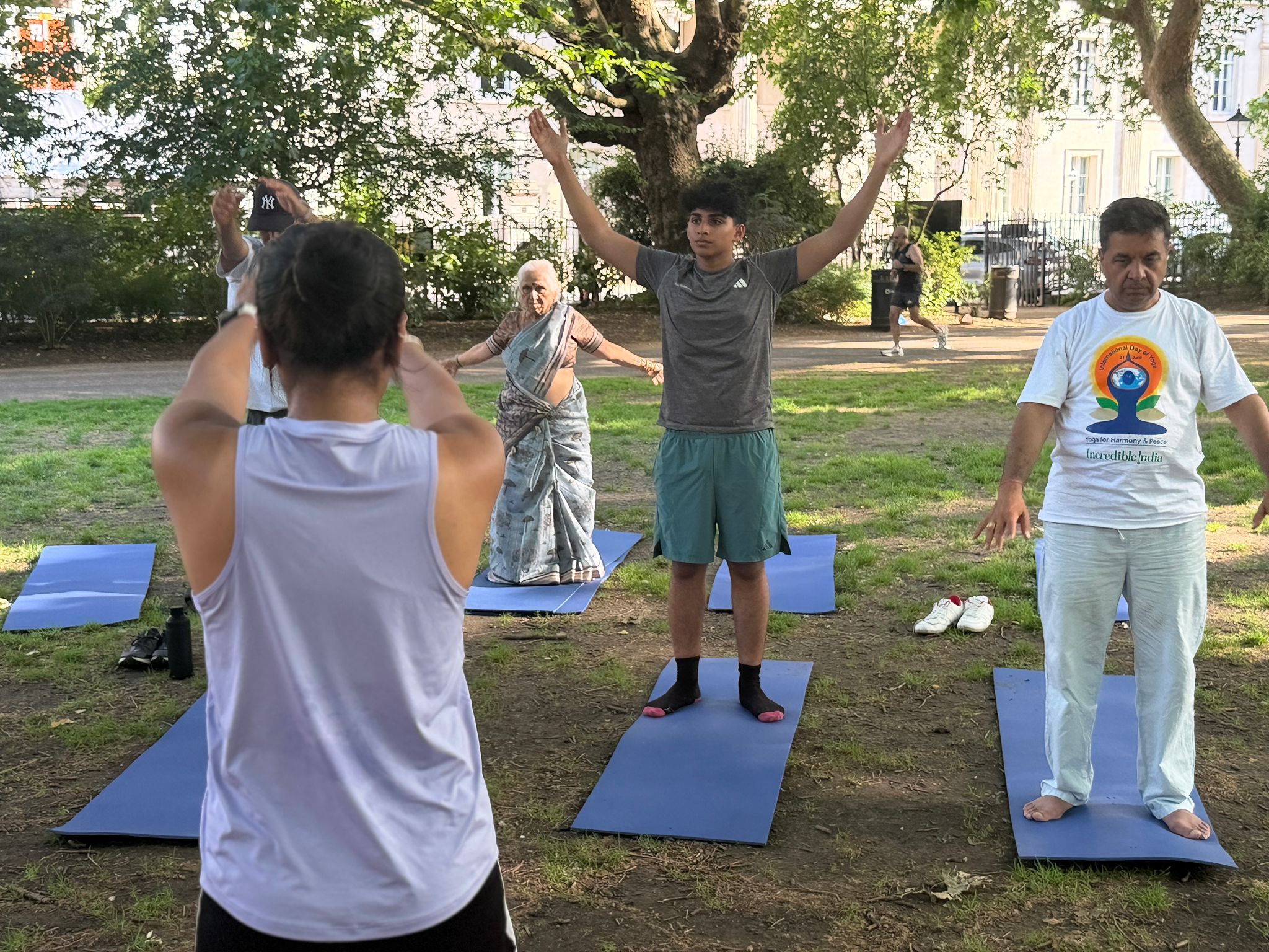 Outdoor group yoga class practising in a park